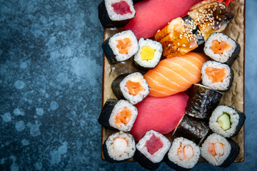 Set of sushi and maki on stone table. Top view with copy space