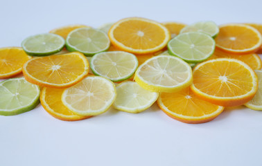 slices of orange and lemon, and lime isolated on white background. Colorful citrus slices pattern, background, texture. With copy space for text. 