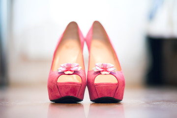 Pink women's shoes on the platform with high heels on a blurred background. Shallow depth of field, close-up shot
