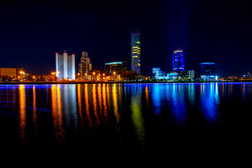 Cityscape of Yekaterinburg, Russia at night with lights reflections on water