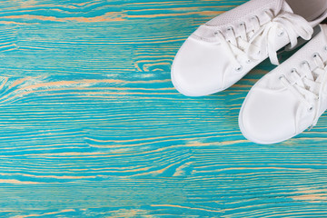 white sneakers on color background. copy space.