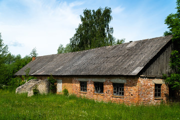 Fototapeta na wymiar Old red brick abandoned warehouse in rural area
