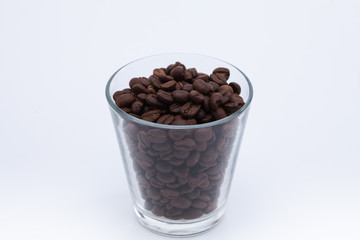 Coffee beans in a glass cup isolated