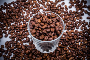 Coffee beans with a glass