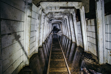 Fototapeta na wymiar Flooded abandoned uranium mine with rusty railway