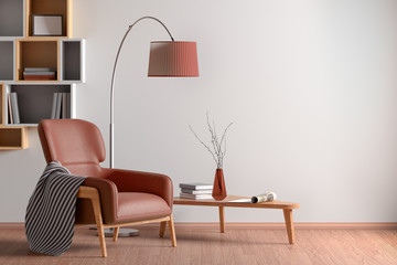 Interior of living room with armchair, coffee table, floor lamp