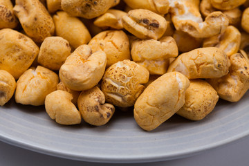 Roasted corn snack in a plate isolated