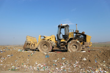 Obraz premium Bulldozer landfill compactor in a sanitary landfill