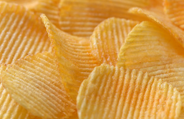 Golden wavy potato chips.