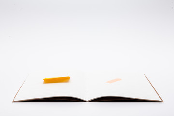 Study note book with empty sticky note isolated on white