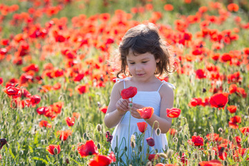 Happy girl with hat in flower field in spring