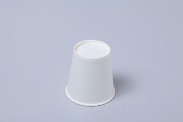 White paper cup on gray