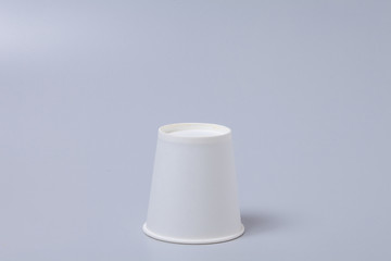 White paper cup on gray