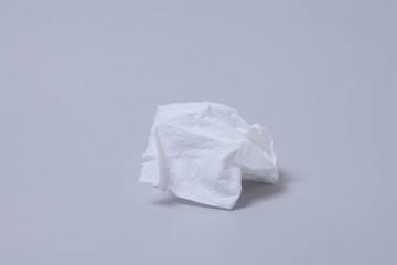 Crumpled toilet roll paper on gray background 