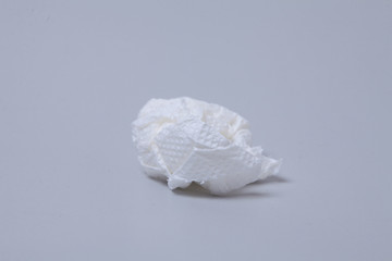 Crumpled toilet roll paper on gray background 