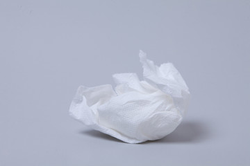 Crumpled toilet roll paper on gray background 