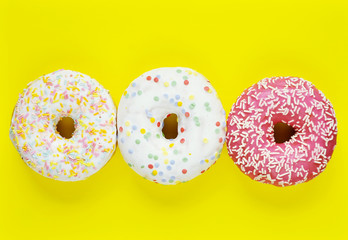 Delicious donuts on light pastel color background.