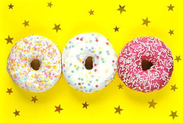 Delicious donuts on light pastel color background.