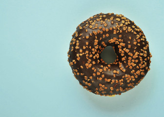 Delicious donuts on light pastel color background.