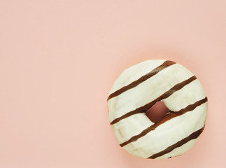 Delicious donuts on light pastel color background.