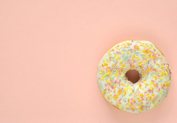Fototapeta na wymiar Delicious donuts on light pastel color background.