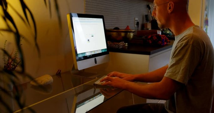 Man using desktop computer at home 4k