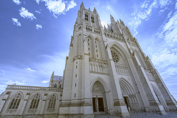 Fototapeta na wymiar Magnificent and impressive gothic cathedral against a blue cloudy sky