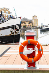 Orange lifebelt at harbor