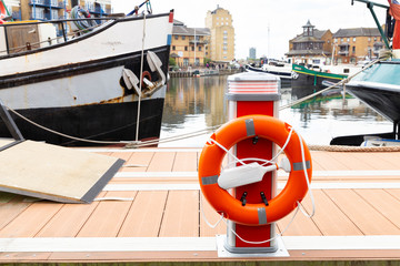 Orange lifebelt at harbor