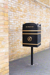 Black metal dog waste bin