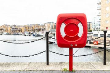 Red life saver buoy ring at Themes port