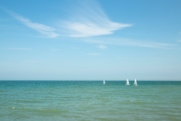 Sea horizon with a cloud and sailboat