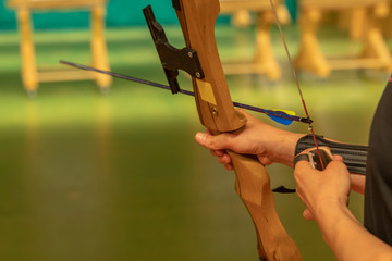 The man puts arrows into the bow during archery