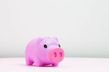  Piggy bank on soft pink background