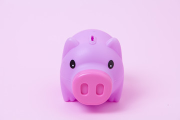 Piggy bank on soft pink background