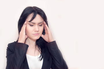 Young woman with black hair. Headache and migraine. Emotions concept. Isolated portrait on white background