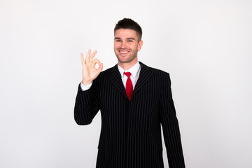 successful young businessman in black suit with red tie