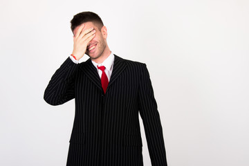 young businessman in black suit have headache because of work and he isn't happy