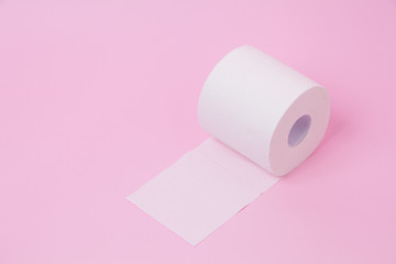 The roll of white toilet tissue paper on pink background