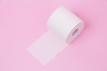 The roll of white toilet tissue paper on pink background