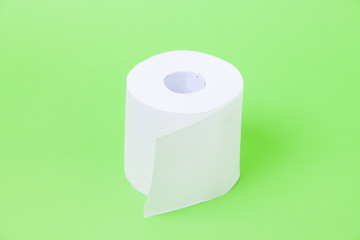 The roll of white toilet eco tissue paper on green background