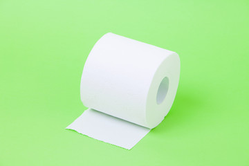 The roll of white toilet eco tissue paper on green background 