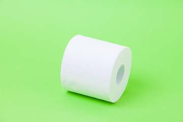 The roll of white toilet eco tissue paper on green background 