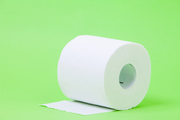 The roll of white toilet eco tissue paper on green background 