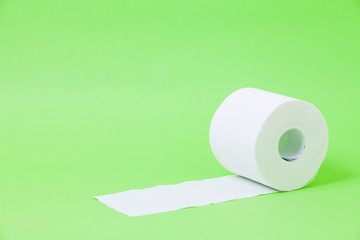 The roll of white toilet eco tissue paper on green background 