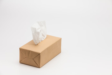 Tissues paper Box with one sticking from the top on a white