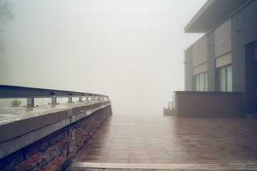 Misty day on mountain range hotel yard tiles fence Old Mountain