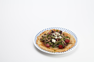 Salad on a Korean pizza on a plate