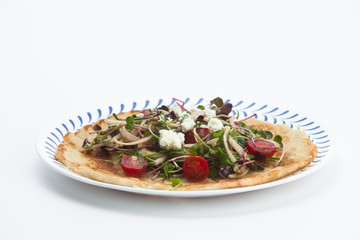 Salad on a Korean pizza on a plate