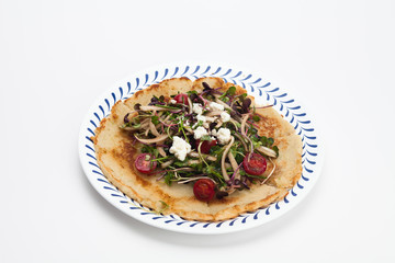 Salad on a Korean pizza on a plate